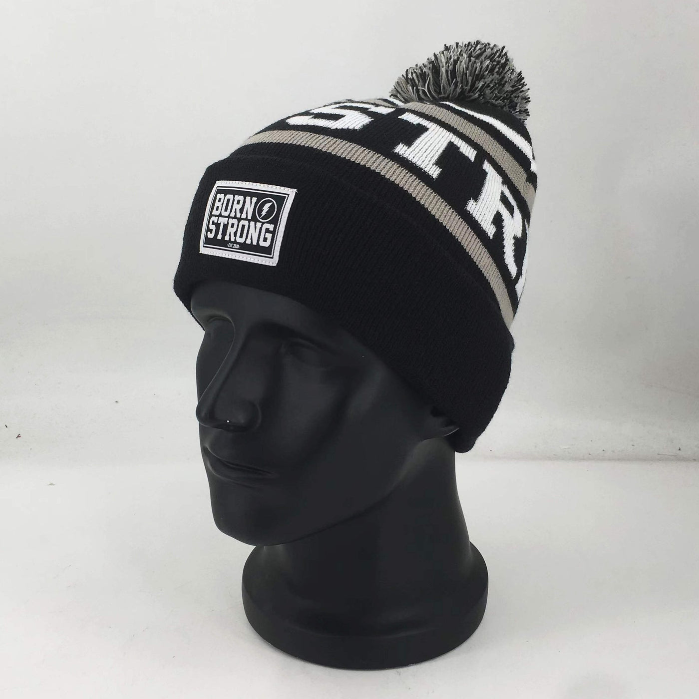 BORN STRONG hoed met pompon - LIMITED EDITION